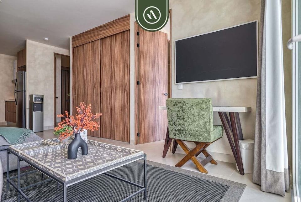 Bright living space with comfortable seating, smart TV, and stylish décor designed for comfort and relaxation.