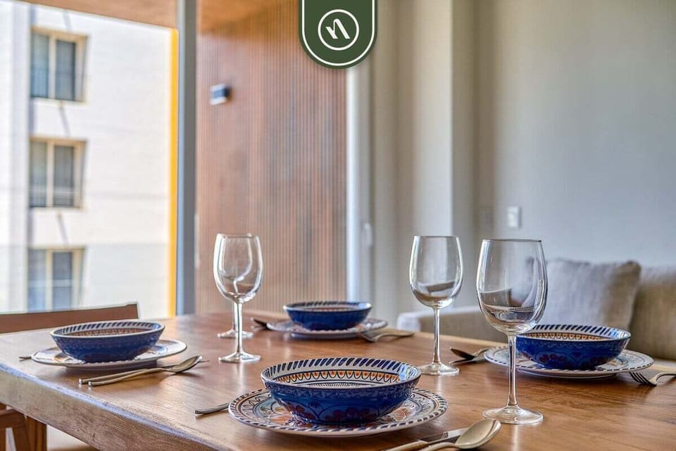 Share memorable meals around the dining table, thoughtfully set and positioned near large windows that fill the space with natural light.