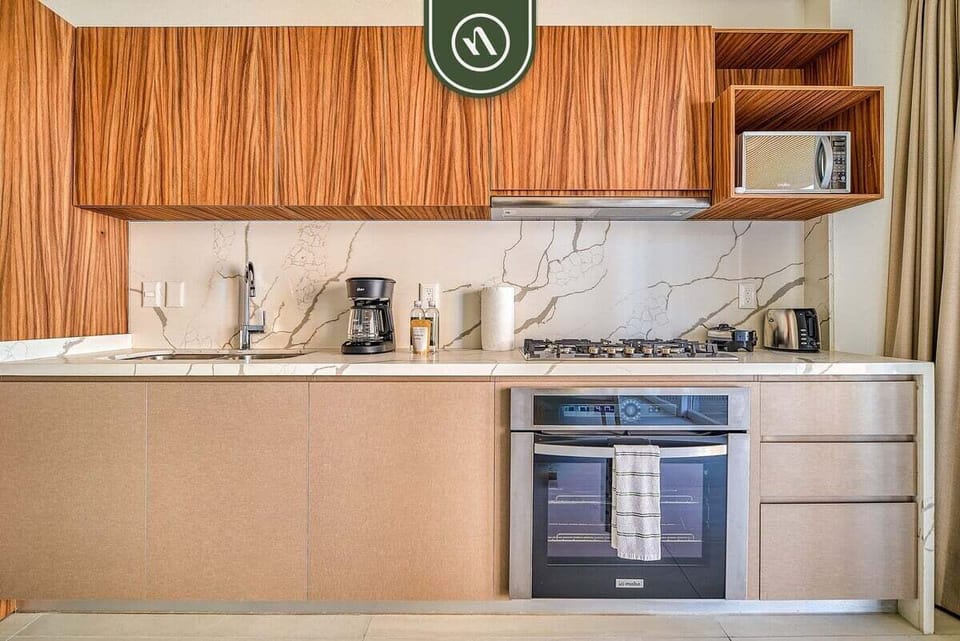 Prepare your favorite dishes in the modern kitchen featuring full-size appliances, ample counter space, and everything needed for a convenient stay.