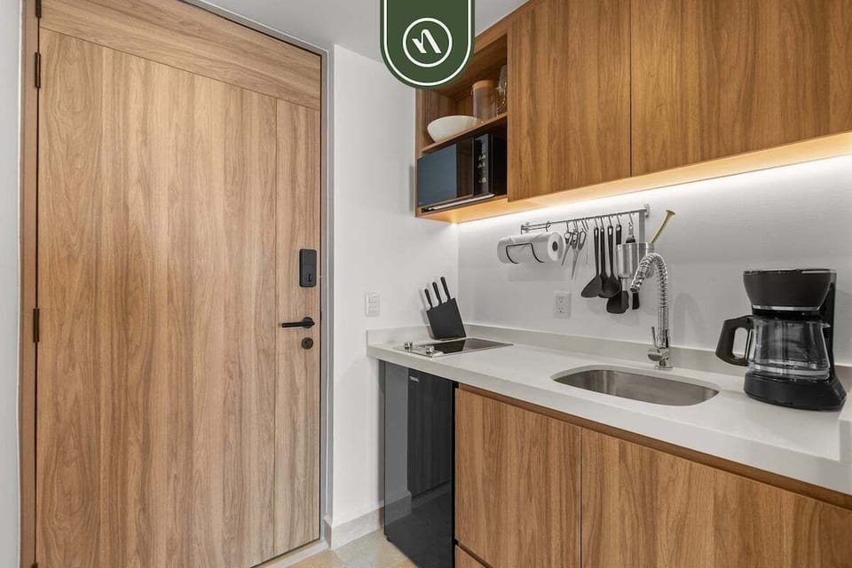 Modern kitchenette with contemporary finishes, sink, and essentials perfect for light meals, snacks, and added convenience during your stay.