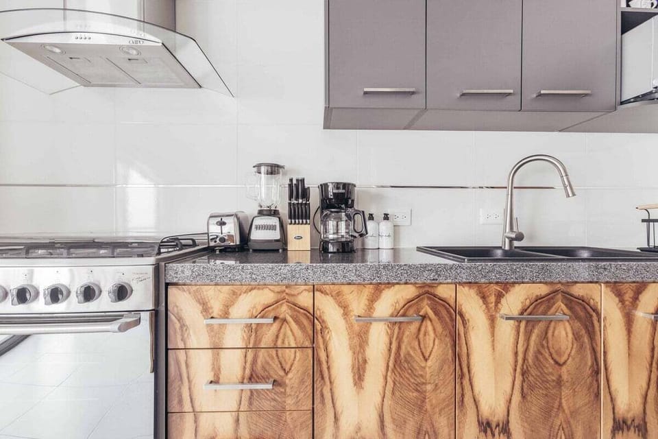 Modern kitchen with quality appliances, ample counter space, and everything needed to prepare meals during your stay.