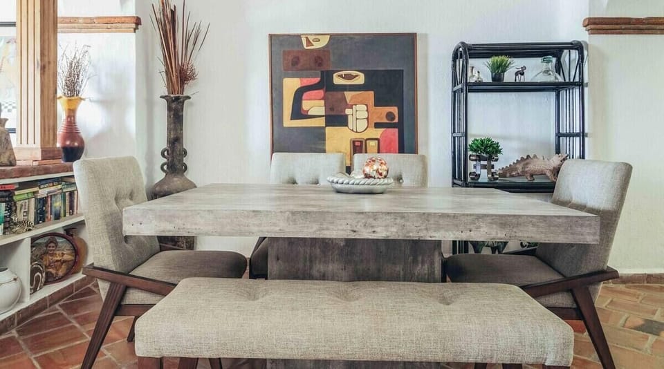 An alternate angle of the dining area showcasing contemporary wall art and a stylish display shelf.