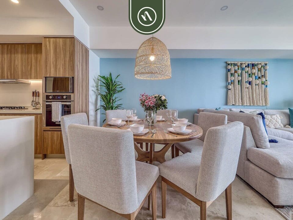 Modern dining area with seating for six, connected to the living room and kitchen. Perfect for shared meals, game nights, or enjoying takeout after a day at the beach in Puerto Vallarta.