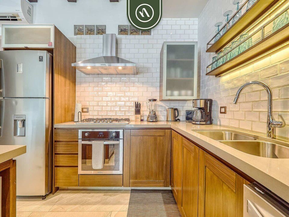 Fully equipped kitchen with modern appliances, dishwasher, and spacious layout