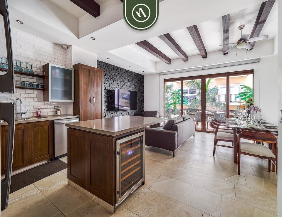 Modern open-concept living and kitchen with natural light and spacious design