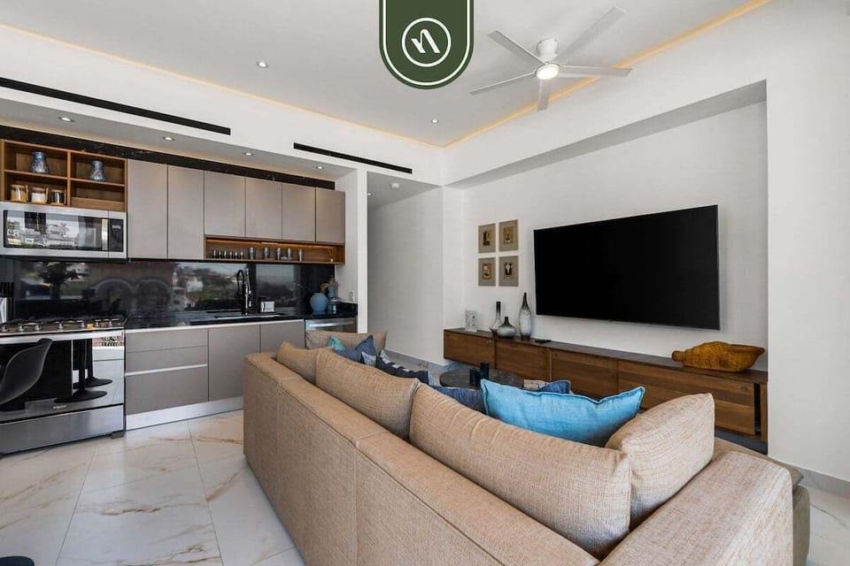 Sophisticated yet welcoming, the living room serves as the heart of the home, combining modern elegance with relaxed coastal living.