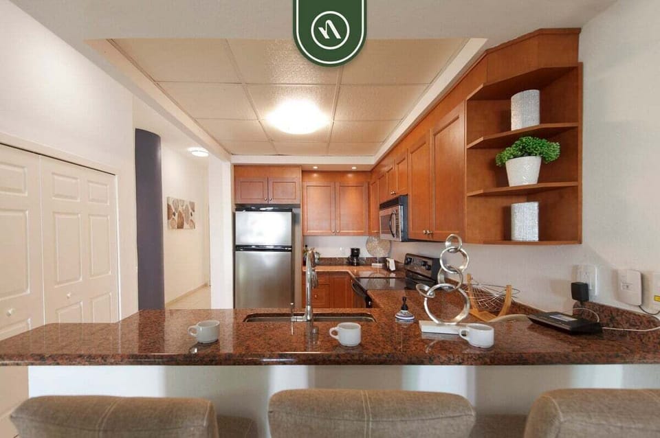 Gather around the spacious breakfast bar and enjoy a fully equipped kitchen designed for easy meals and entertaining.