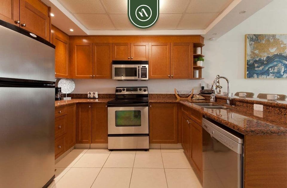 Prepare meals with ease in the fully equipped kitchen featuring granite countertops, stainless steel appliances, and ample workspace.