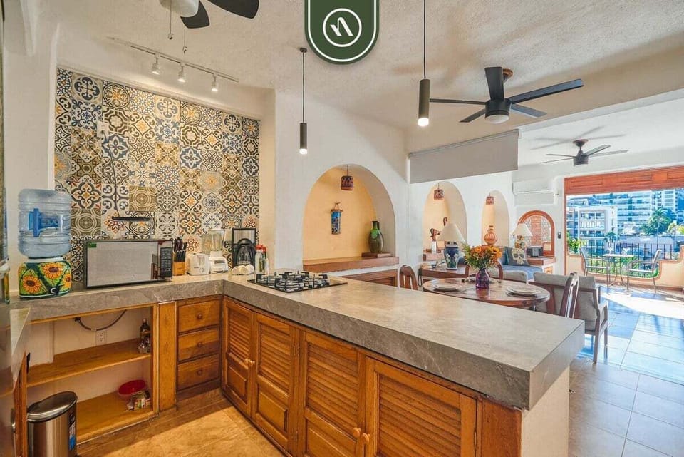 Prepare meals with ease in a modern kitchen complete with essential appliances, cookware, and ample counter space.