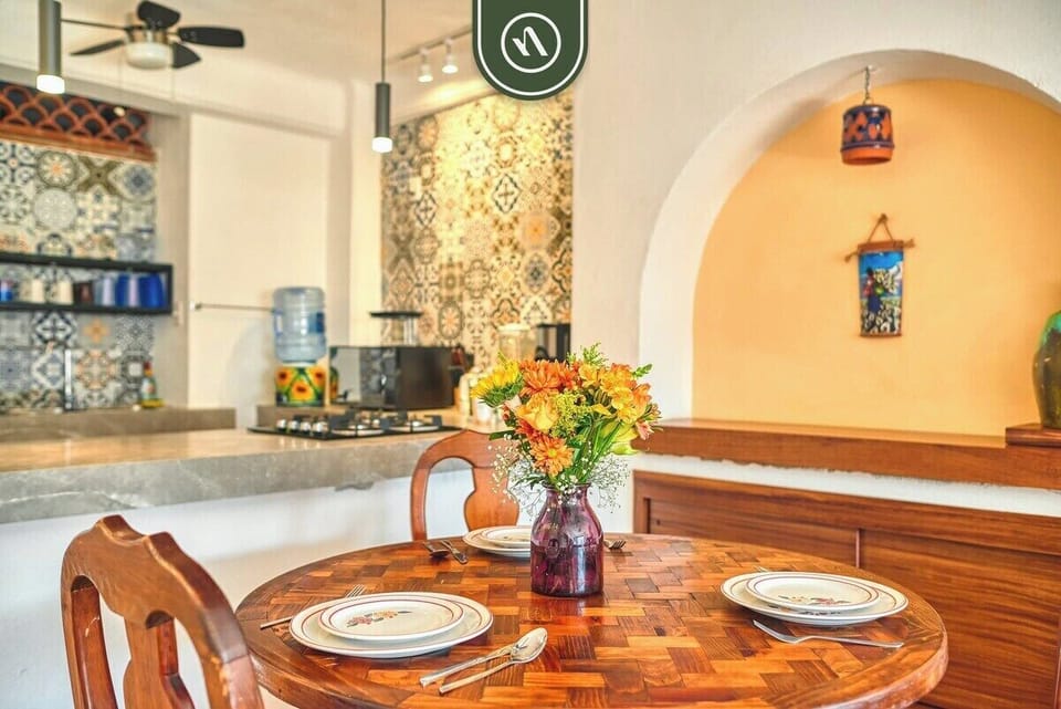 Relax in a stylish open-concept living space with comfortable seating, natural light, and charming Mexican-inspired décor.