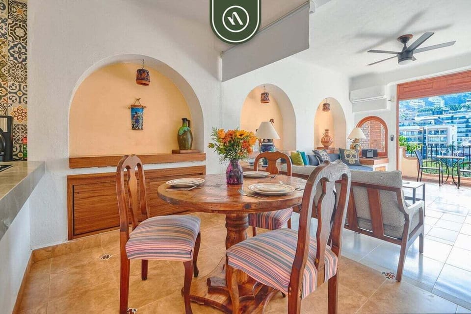 Relax in a stylish open-concept living space with comfortable seating, natural light, and charming Mexican-inspired décor.