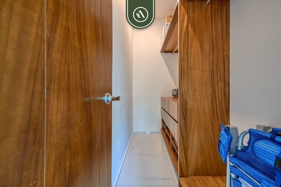 Unpack and settle in easily with this spacious custom wooden closet. Perfect for storing your luggage and beach gear.