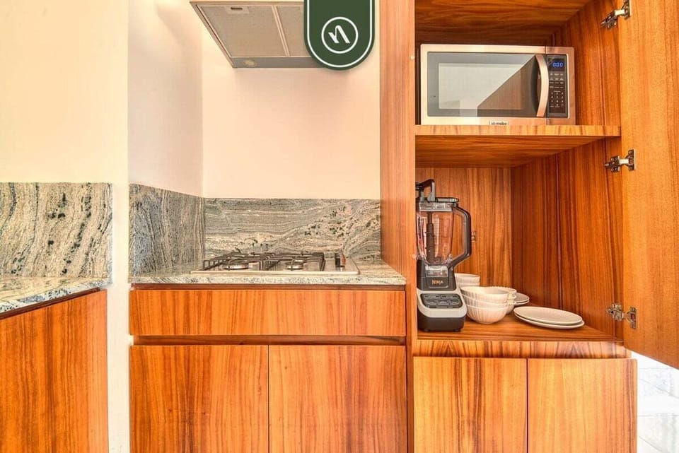 Enjoy the convenience of modern built-in appliances and a blender perfectly tucked away inside beautiful custom wood cabinetry.