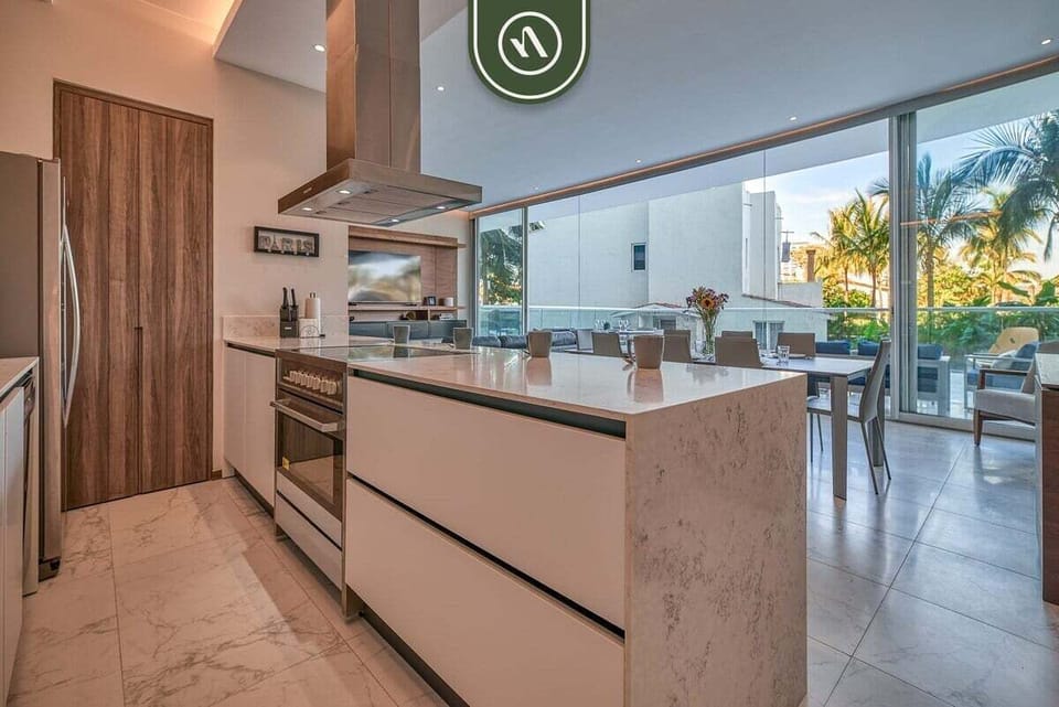 A sleek open-concept kitchen with premium finishes, spacious countertops, and direct access to the dining and outdoor living areas.