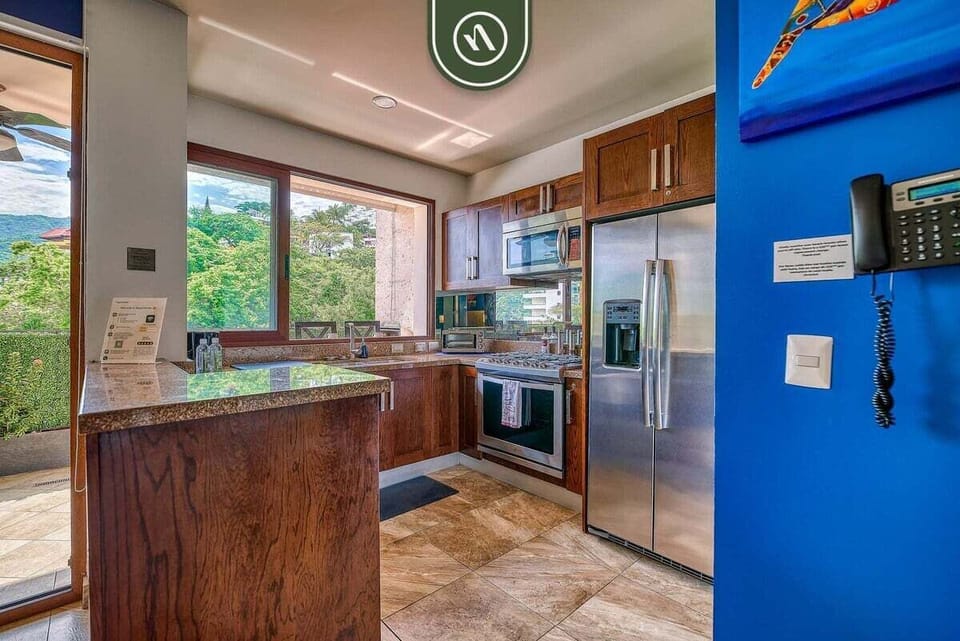 Cook with ease in this spacious kitchen offering sleek granite countertops, rich wood cabinetry, and full-size stainless steel appliances.