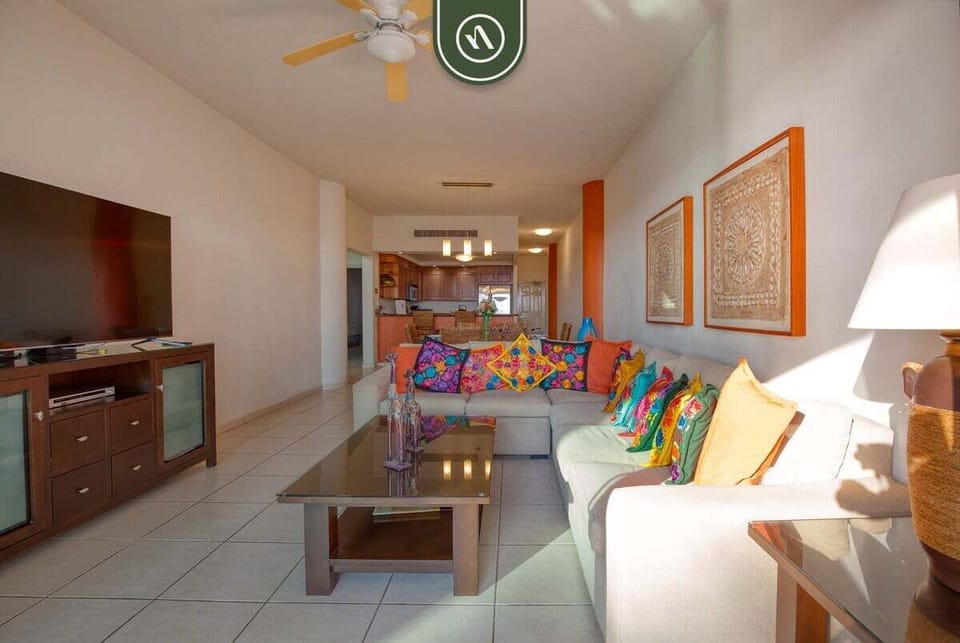 Gather with family and friends in the bright living room featuring comfortable seating and an open layout connecting the main living spaces.