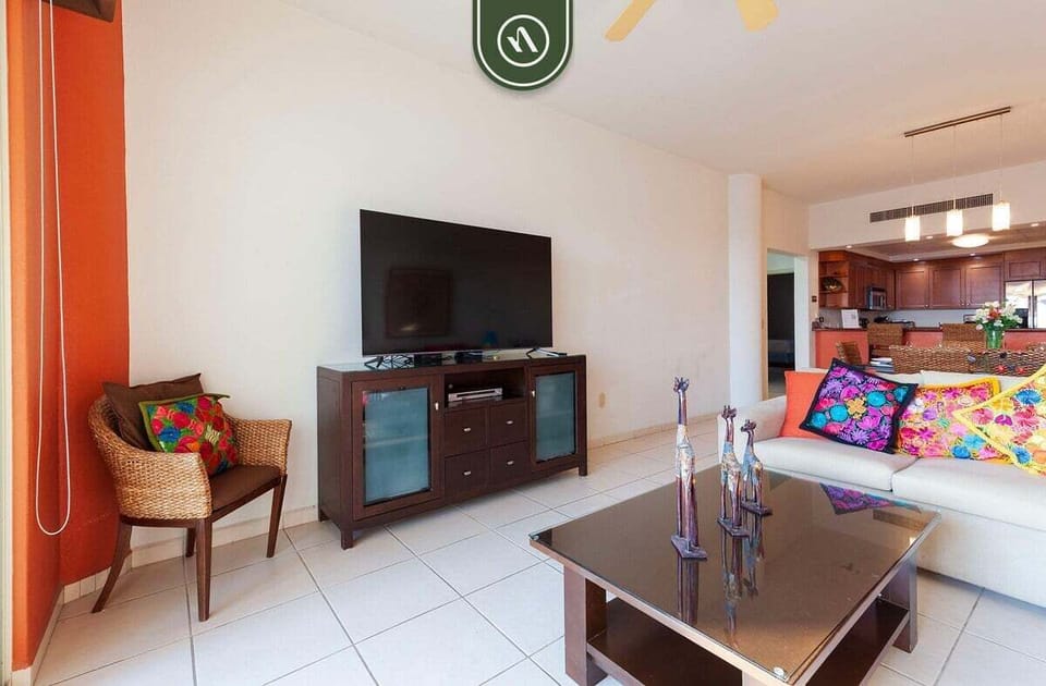 Kick back after a day at the beach in the welcoming living room with cozy seating, entertainment options, and plenty of natural light.