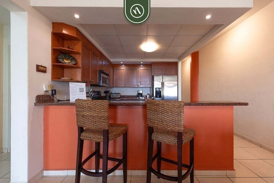 Enjoy casual meals and morning coffee at the breakfast bar, seamlessly connected to the fully equipped kitchen.