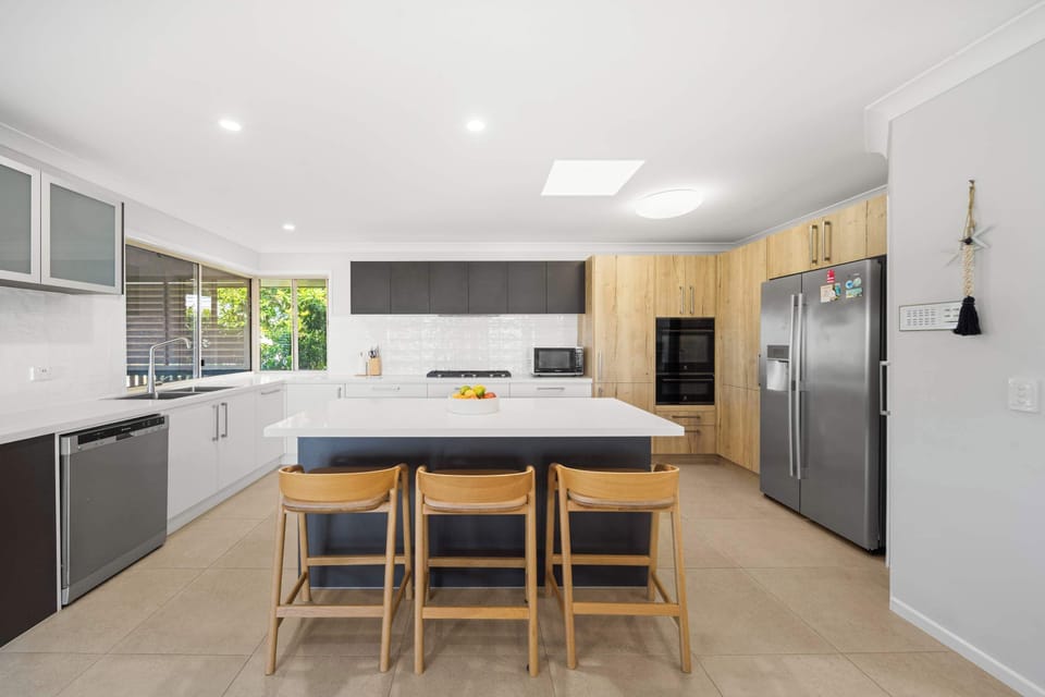 Cook up a feast in the modern kitchen while the kids play in the pool below.