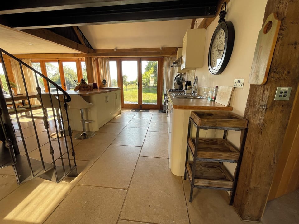 Kitchen with double doors opening onto decking and garden