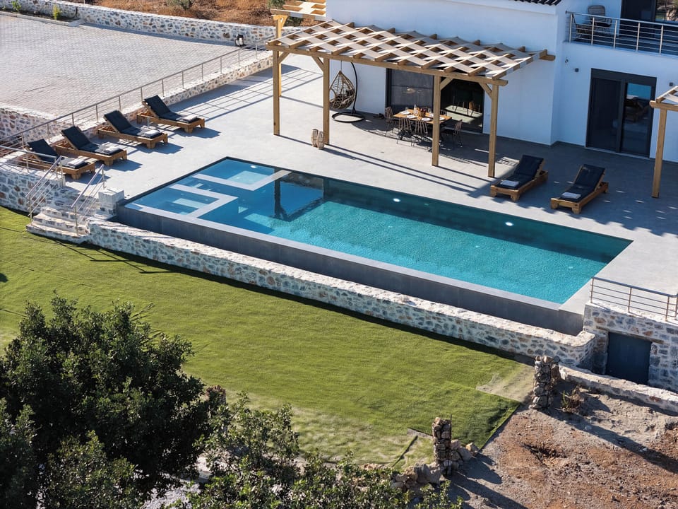 Dive into serenity in your 50m² heated pool with sea-kissed views.