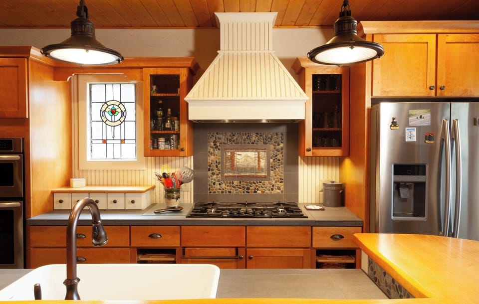 Step into your fully-equipped kitchen with custom cabinetry, stainless appliances, a gas range, and charming details like pendant lighting and a decorative backsplash—ready for your home-cooked meals.