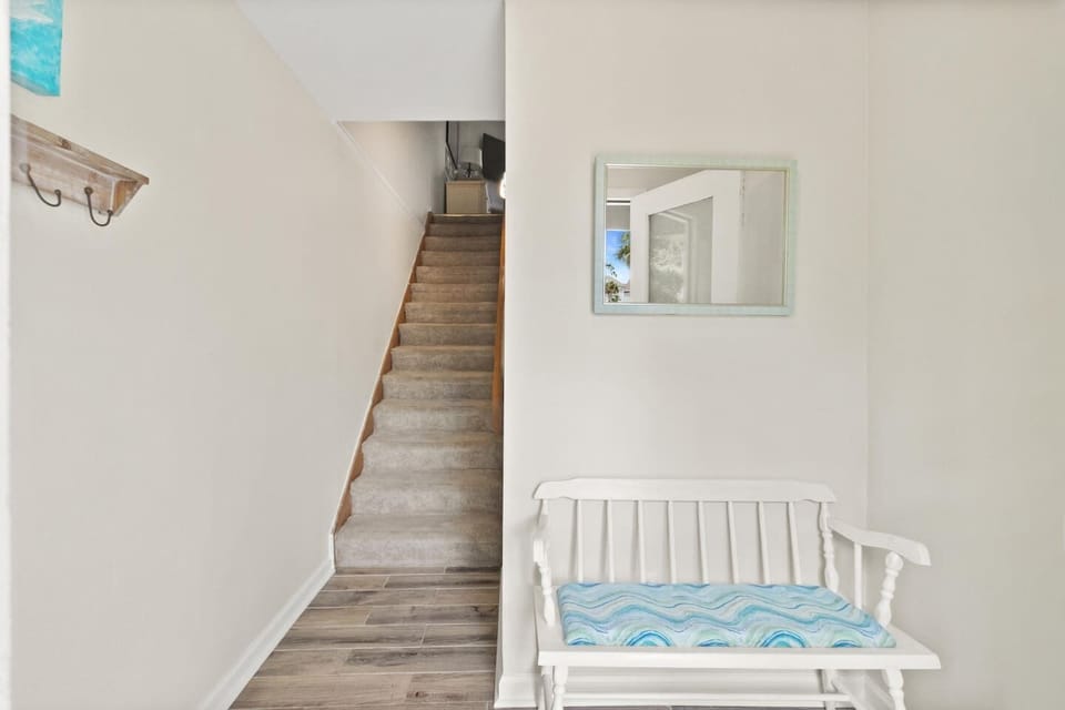 Walk through the ground-level foyer and leave the outside world behind — the beach house starts here.