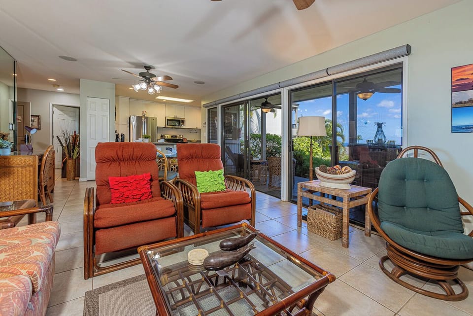 Relax in this bright, island-inspired living space where comfortable seating and open-plan design meet. Sliding doors frame your private lanai and ocean views, blending indoor comfort with tropical breezes.