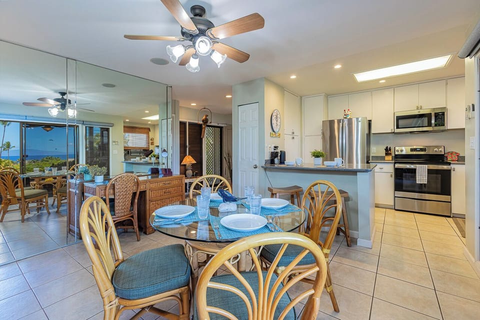Gather around the glass-top table for meals with ocean breezes, then step into the fully equipped kitchen where stainless steel appliances and ample counter space make cooking a joy.