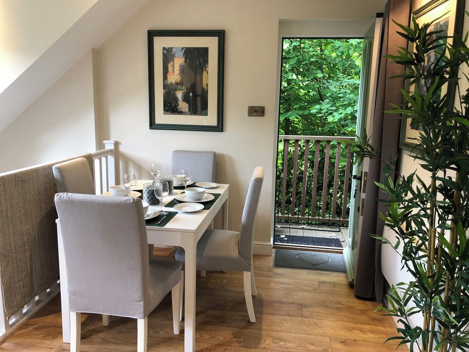 Dining table laid up with The Nest place settings, seats 4-6. Lovely airy space.