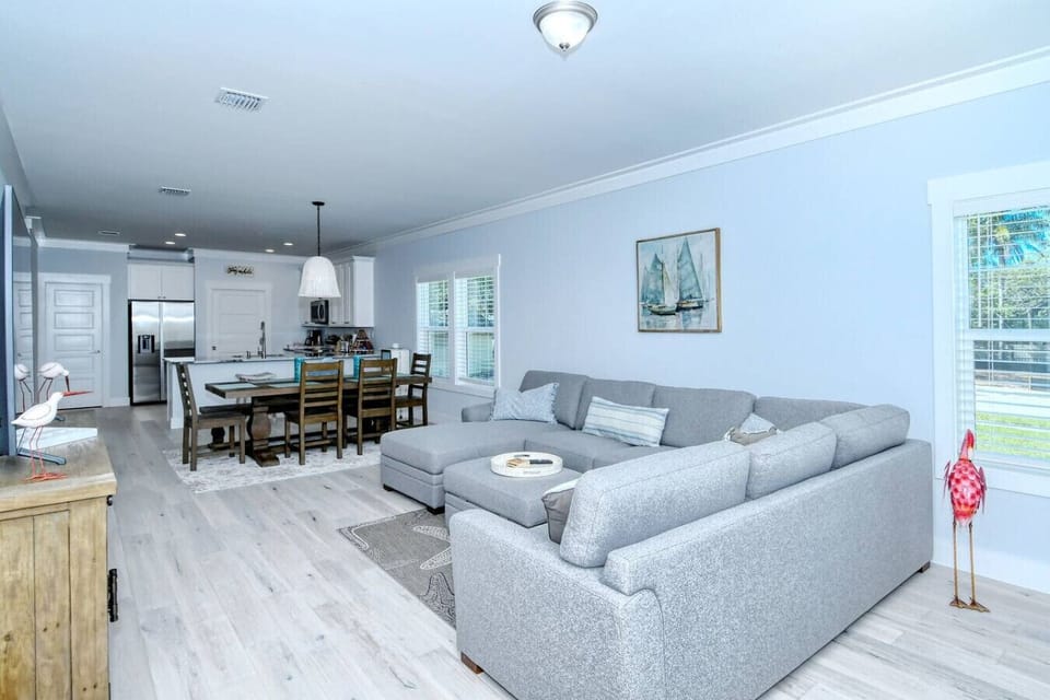 Spacious open-concept living and dining area with comfortable seating and plenty of natural light