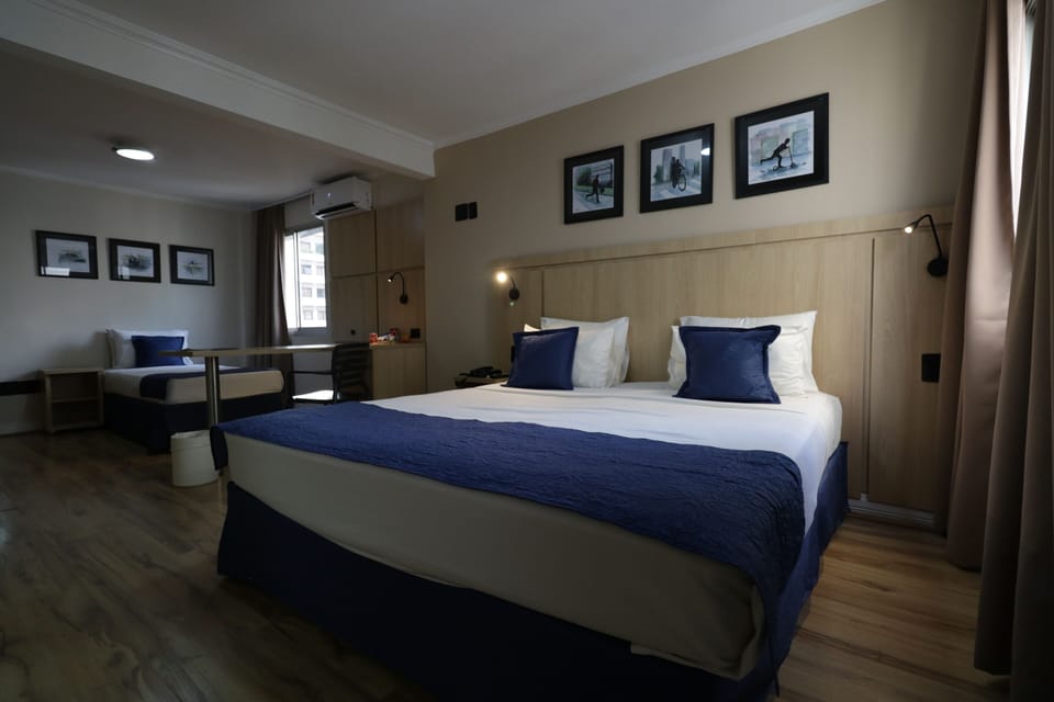 Deluxe Triple Room, City View | Minibar, laptop workspace, WiFi (free), bed sheets