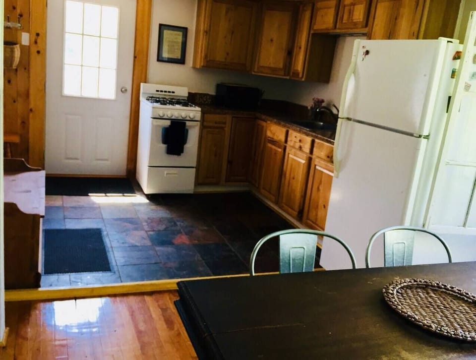Open kitchen fully equipped for cooking meals.