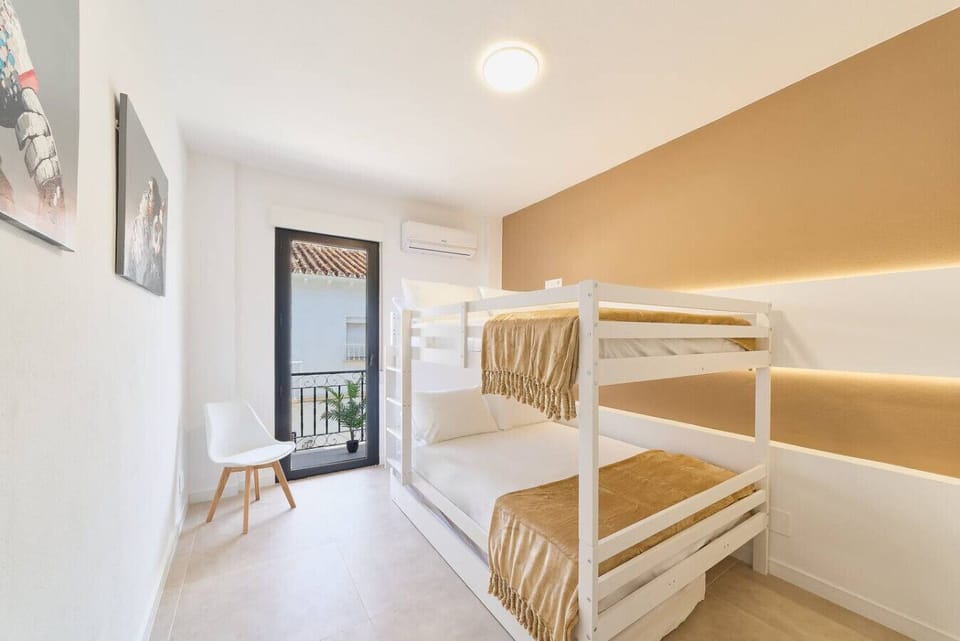 Room with two double beds (135cms x 200cms) and a pull out single bed with access to the terrace.