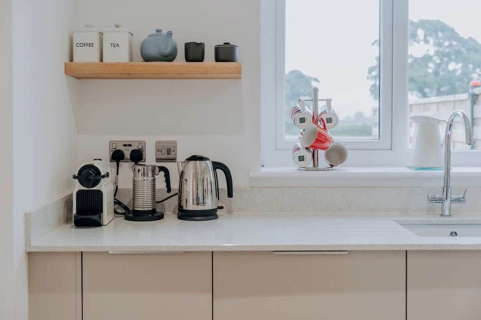 Start your morning right with a fresh Nespresso coffee in the light-filled kitchen — complete with a milk frother, kettle, and thoughtful touches that make every stay at Cliftonville Cottage feel effortlessly homely.