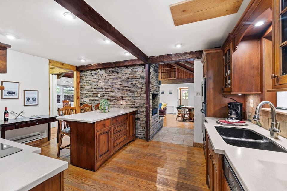 Open and accessible to the main room on two sides, there is excellent flow in and out of this designer kitchen for a gathering.