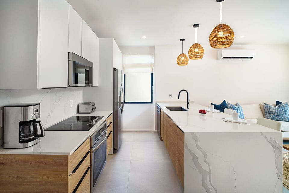 The open-plan layout flows seamlessly from the living area to the kitchen