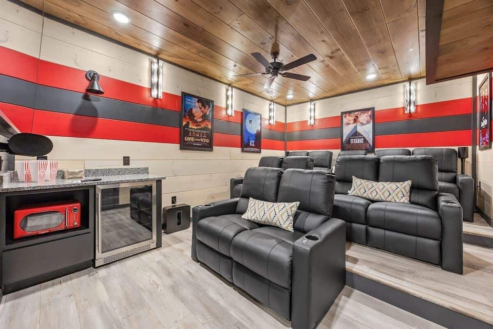 Modern home theater with tiered leather seating and movie posters