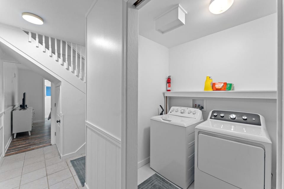 The laundry room has a full-sized washer and dryer