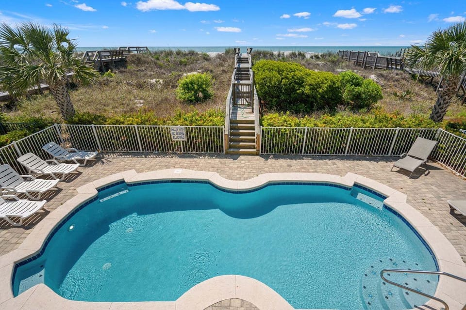 Private pool with lounge chairs and beach steps at Sea Star, a 6-bedroom Cherry Grove vacation rental in North Myrtle Beach