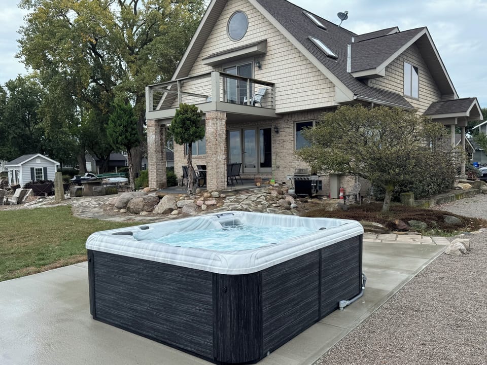 Soak your worries away in this private hot tub while enjoying peaceful views of the beautifully landscaped property.