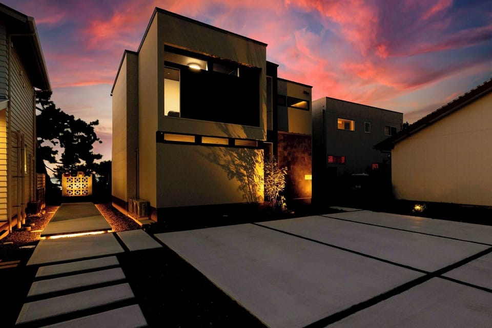 The exterior blends seamlessly into the evening scenery, signaling the start of a special stay.