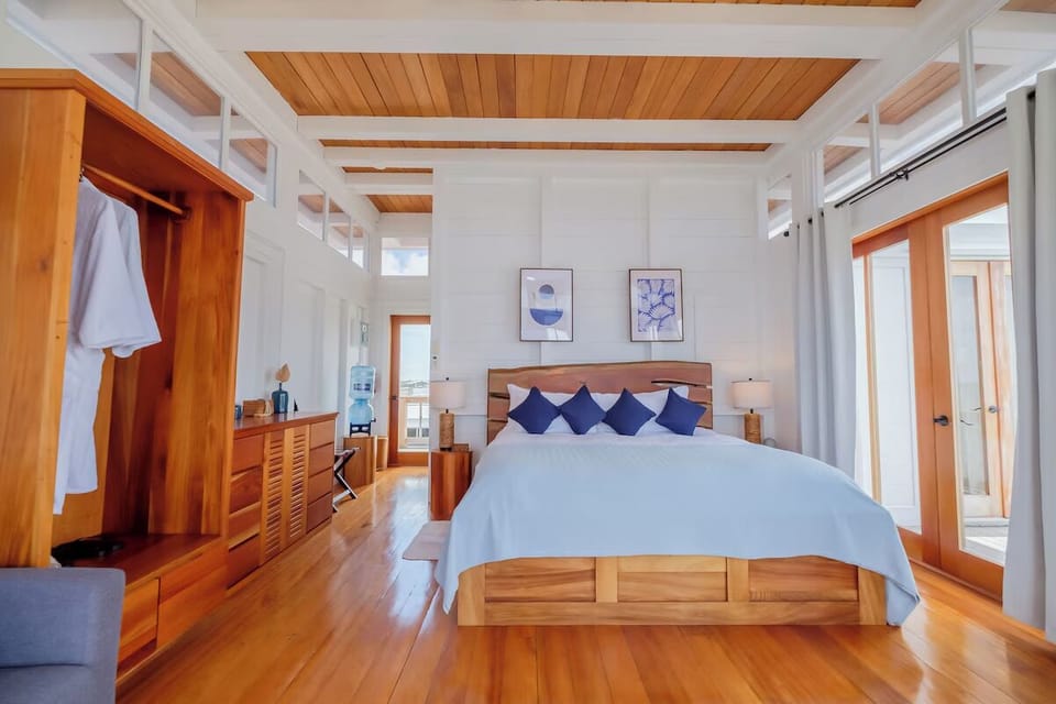 Drift off under lofty beams in a serene coastal space.