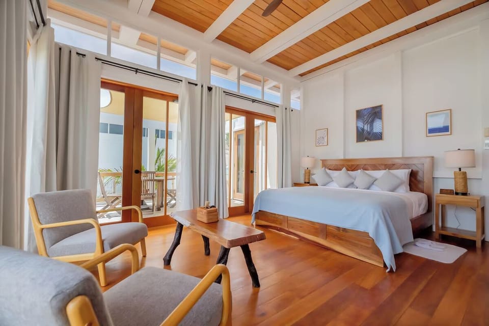 Lounge in sunlit serenity beside your cloud-soft king bed.
