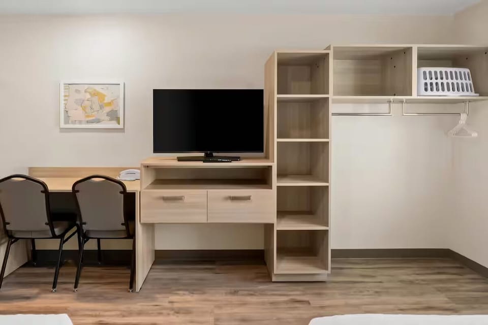 Organize effortlessly with open shelving, closet space, and TV.