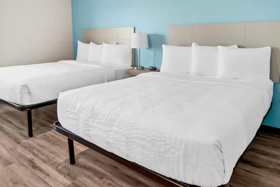 Relax in bright comfort with plush beds and fresh white linens.