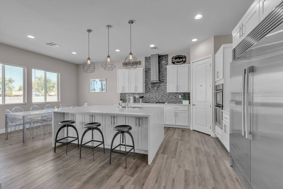 Features a striking waterfall island, custom cabinetry, and top-of-the-line stainless steel Electrolux appliances.