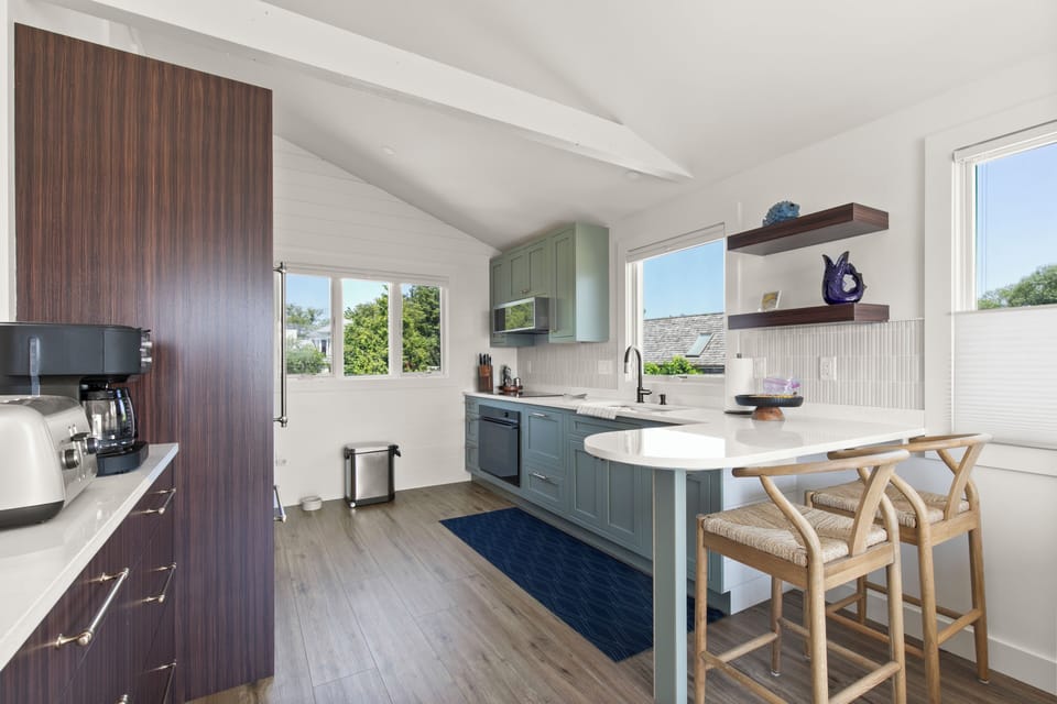 The modern kitchen is equipped with full-size appliances and a breakfast bar