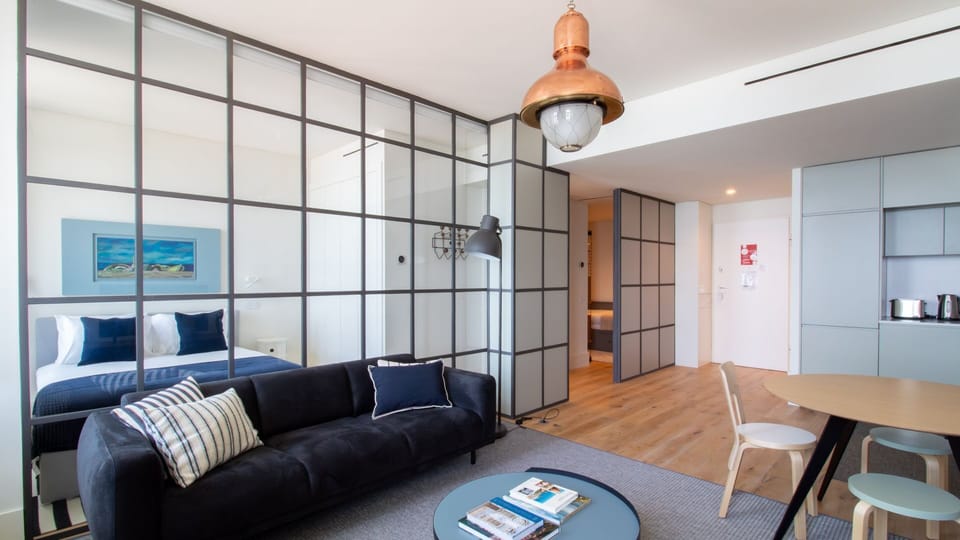Modern design meets comfort in this chic space, connecting bedroom and lounge seamlessly. #ModernLiving #DesignApartment #Foz #LovelyStayHomes