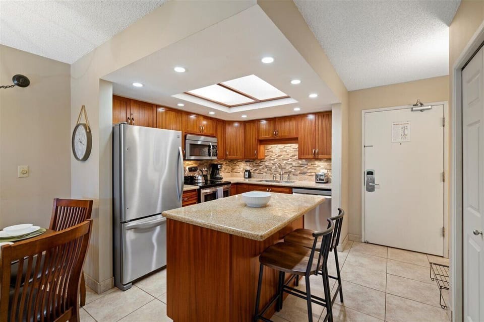 Bright, open kitchen with breakfast bar seating for two